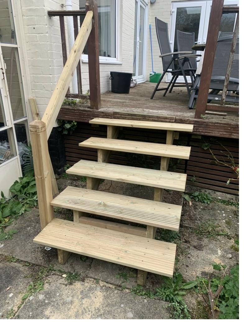 Newly built pressure-treated timber deck staircase with four wide steps and handrail, Cambridge